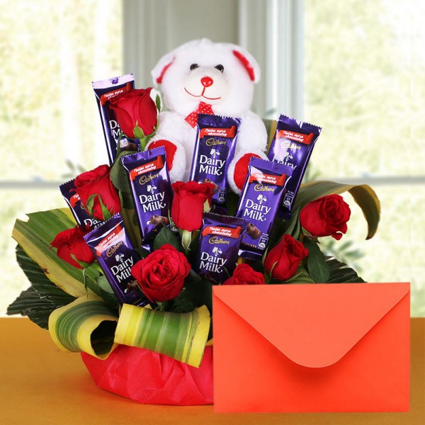 8 Red Roses with 8 Cadbury's DairyMilk Chocolates (14gms each) and Teddy Bear (6 inches) and Greeting Card in a Basket