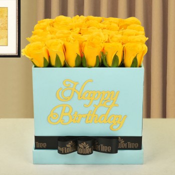 30 yellow roses in happy birthday blue box tied with black ribbon
