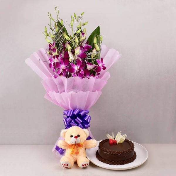 6 Purple Orchids in Paper Packing with Half Kg Chocolate Cake and Teddy Bear (6 inch)