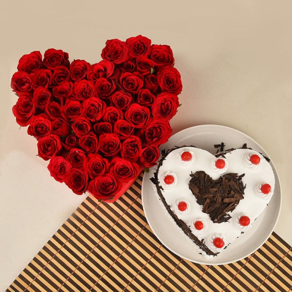Heart Shaped Arrangement of 50 Red Roses with 1 Kg Heart Shape Black Forest Cake