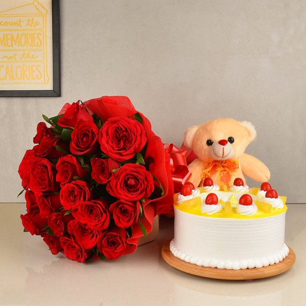 20 Red Roses wrapped in crape paper with Half Kg Pineapple Cake and 6 Inches Pink Teddy