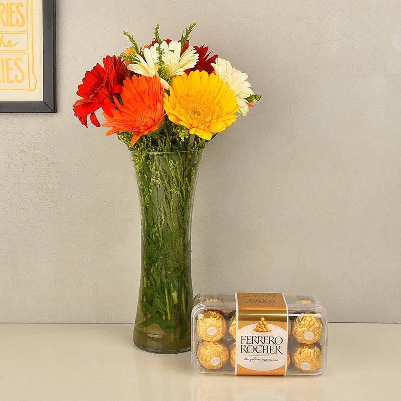 12 Assorted Gerberas in Glass Vase with a box of 16 pcs of Ferrero Rocher