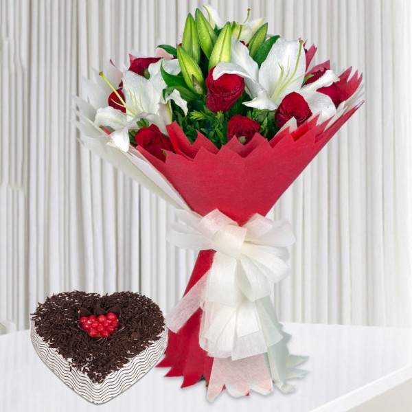 12 Red Roses and 3 White Asiatic Lilies with 1 Kg Heart Shape Black Forest Cake in White and Red Paper Packing in White Bo