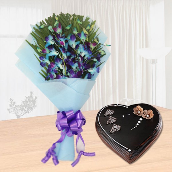 6 Blue Orchids with 1 Kg Heart Shaped Chocolate Truffle Cake in Blue Paper Packing