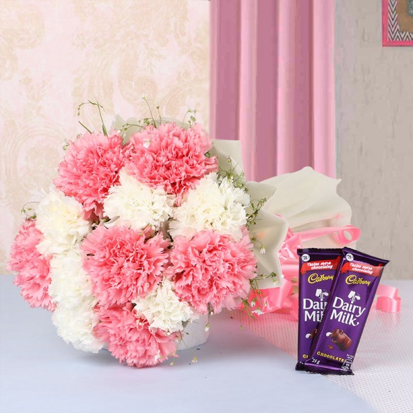 12 Carnations (Pink and White) in White Paper packing with 2 Cadbury Dairy Milk Chocolates (25gms each)
