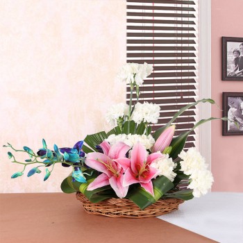 2 Pink Asiatic Lilies, 10 White Carnations and 2 stems of Blue Orchid in a Basket