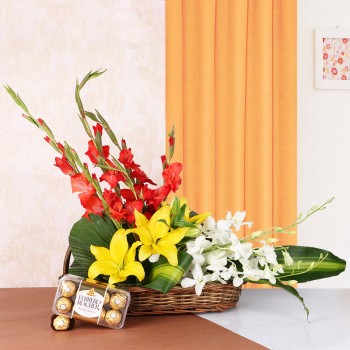 Floral Arrangement is the best gift ever. It has 3 Yellow Asiatic Lilies, 4 Red Glads and 3 White Orchids in a Basket with a box of 16 pcs of Ferrero Rocher Chocolates