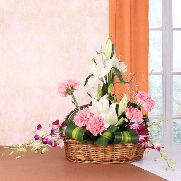 Floral Arrangement of 4 White Asiatic Lilies, 5 Pink Carnations and 4 Purple Orchids in a Basket