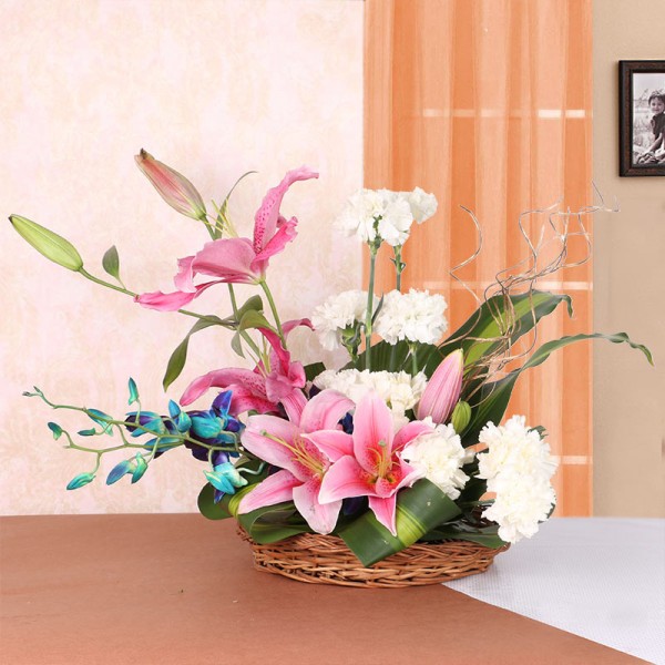 Floral Arrangement of 4 Pink Asiatic Lilies, 10 White Carnations and 2 Blue Orchids in a Basket