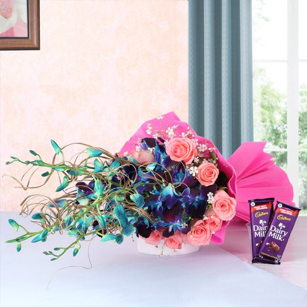 6 Blue Orchids and 12 Pink Roses in Pink Paper packing with 2 Cadbury Dairy Milk Chocolates (25gms each)