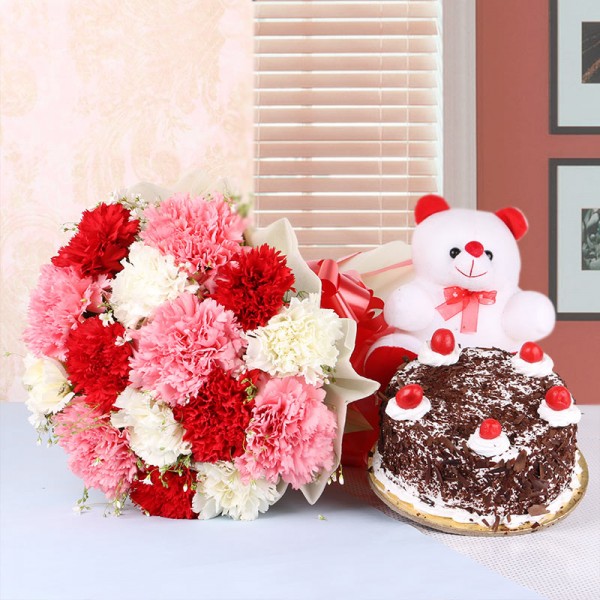 15 Mix Carnations in White Paper packing with Black Forest cake (Half Kg) and Teddy Bear (6 inches)