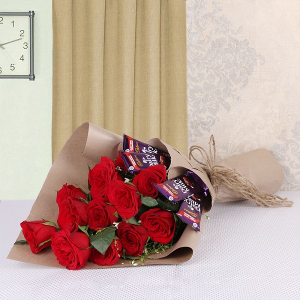 Arrangement of 12 Red Roses and 4 Dairy Milk Chocolates (13gms each)