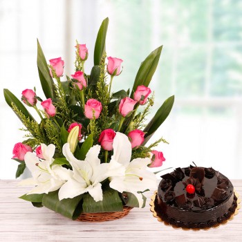 Floral Basket Arrangement in 15 Pink Roses and 2 White Asiatic Lilies with Half Kg Chocolate Truffle Cake
