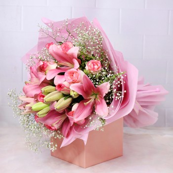 5 Pink Asiatic Lilies and 8 Dark Pink Roses and 4 White Glads in a Glass Vase
