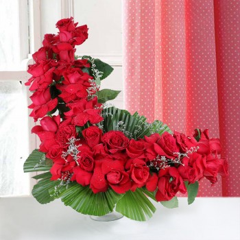 floral arrangement of 25 Red Roses in glass vase