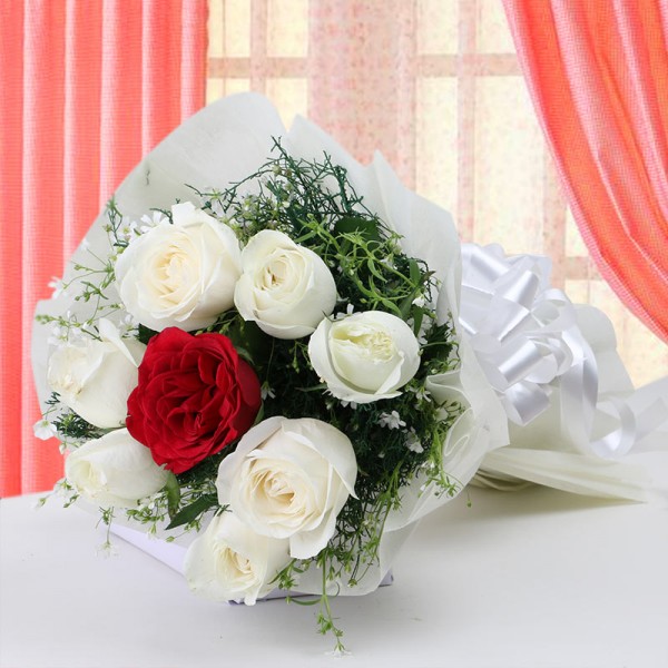 7 White Roses with 1 Red Rose in Paper Packing
