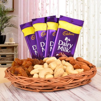  A Basket containing Almonds (100 gms), Cashew Nuts (100 gms) and Raisins (100 gms) and 4 Cadbury's Dairy Milk Chocolates (13.2 gms each)
