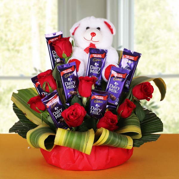  8 Red Roses with 8 Cadbury's DairyMilk Chocolates (14gms each) and Teddy Bear (6 inches) in a Basket