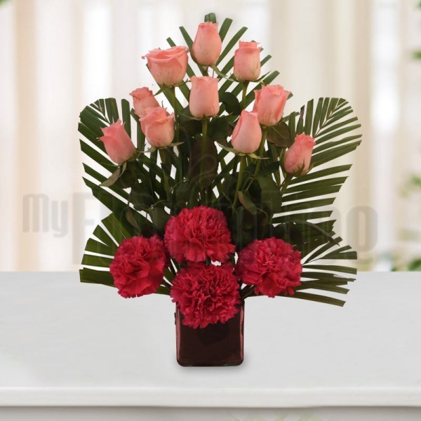10 Pink Roses and 4 Pink Carnations with Arica Palm Leaves in a Square Glass Vase