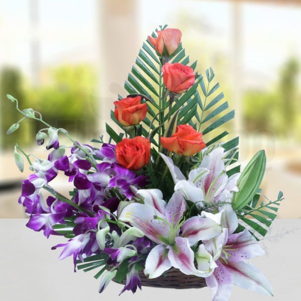 5 Orange Roses and 3 Pink Oriental Lilies and 3 Purple Orchids with Arica Palm Leaves in a Basket