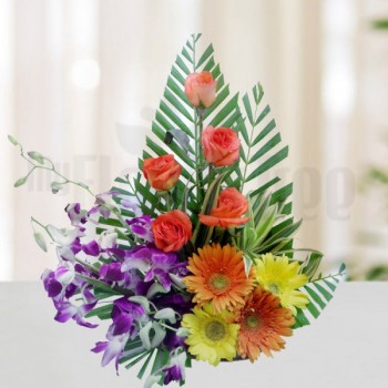 5 Orange Roses and 4 Yellow Gerberas and 3 Purple Orchids with Arica Palm Leaves in a Basket