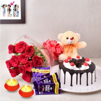 12 Red Roses with 5 Cadbury's DairyMilk Chocolates (13.2 gm) and Half Kg Black Forest Cake and Teddy Bear (6inches) along with Set of 2 Diya