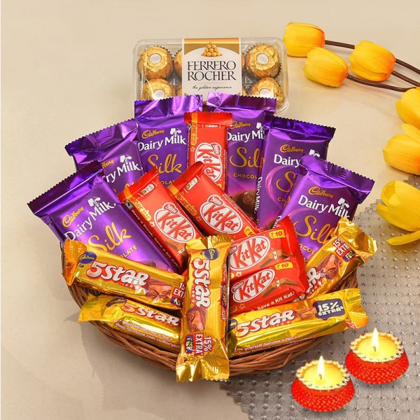 A Chocolate Basket of 5 kitkat (13.2gms each), 5 5star (22.4gms each), 6 DairyMilk silk (60 gms each), 16pcs ferrero rochers (200gms) and Set of 2 Diya for Diwali