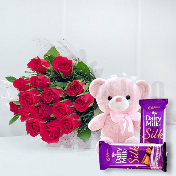 15 Red Roses in Cellophane Packing, Red Bow with 2 Cadbury's DairyMilk Silk (60gms each) and 1 Teddy Bear (6 inches)