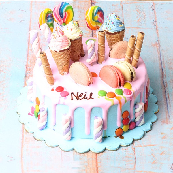 One Kg Vanilla Fondant Cake including Macaroons,Butterscotch Ice Cream Cone,Gems,Choco Stick,Marsh Mello,Stick Candies