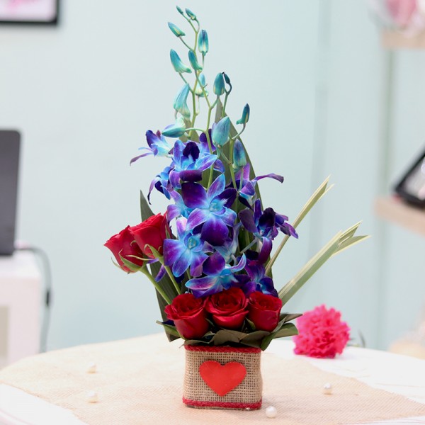  5 Red Roses and 4 Blue Orchids in a Glass Vase