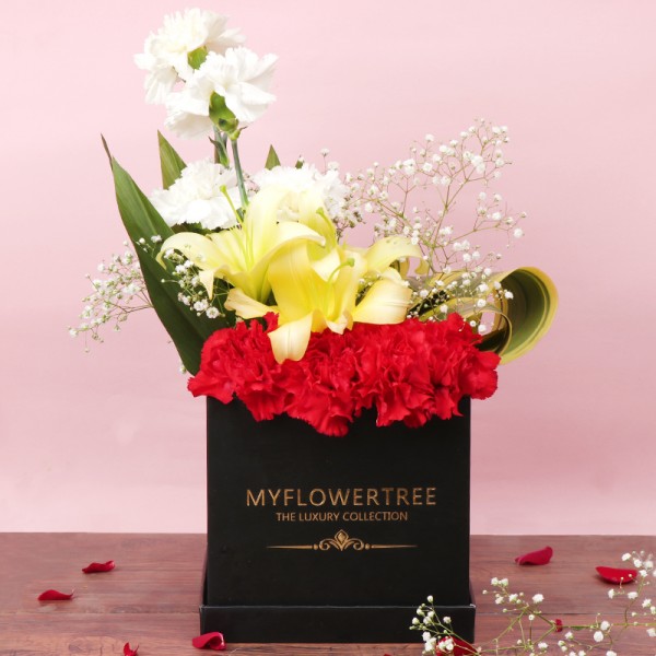 4 White Carnations,4 Red Carnations,3 Yellow Asiatic Lilies Arrangement in Black MFT Luxury Box