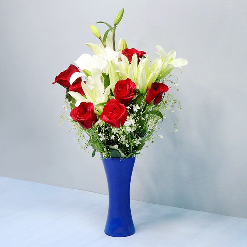 12 Red Roses and 4 White Asiatic Lilies in Red paper packing