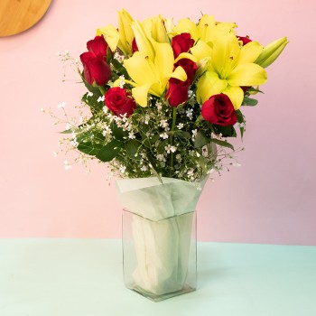 15 Red Roses and 4 Yellow Asiatic Lilies in a Glass Vase