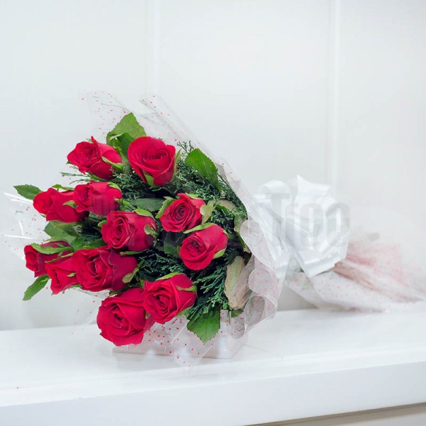 12 Red Roses wrapped in cellophane