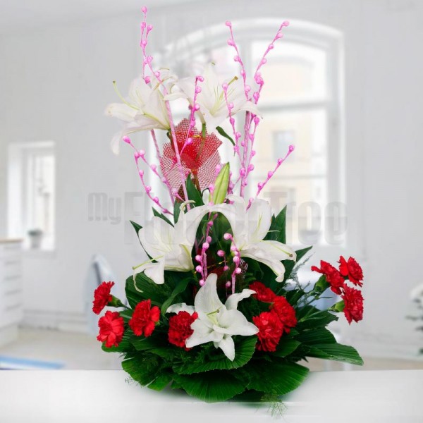 6 Asiatic White Lilies and 10 Red Carnations arranged in a Basket