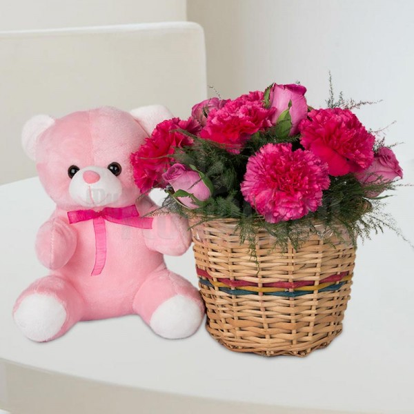12 Pink (Roses and Carnations) arranged in a basket with 6 Inches Teddy