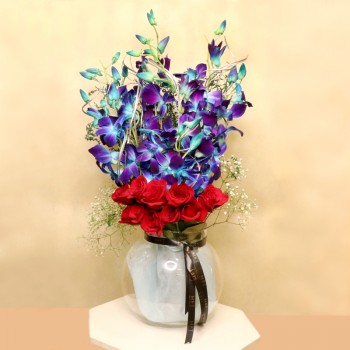 10 Orange Roses with 6 Blue Orchids in a Glass Vase