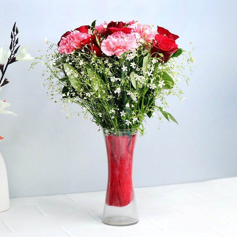 6 Light Pink Carnations and 8 Red Roses in a Glass Vase