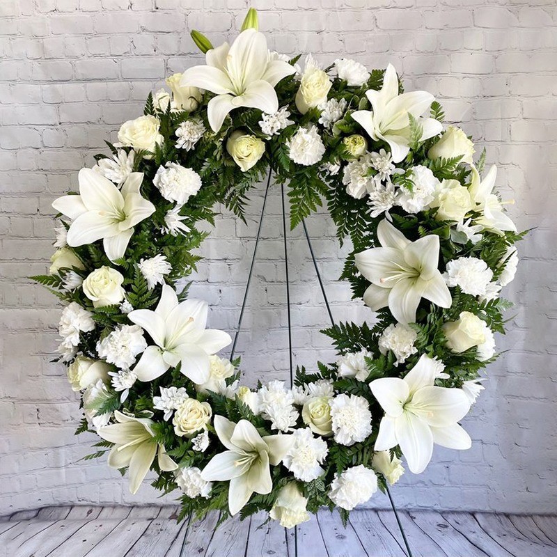 1 Fresh Wreath of 4 Oriental White Lily and 30 White Carnation and 10 White Gerbera and 15 White Roses