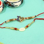 Admiring Pearl N Peacock Rakhi