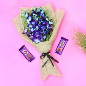 6 Blue Orchids and 12 Pink Roses in Pink Paper packing with 2 Cadbury Dairy Milk Chocolates (25gms each)